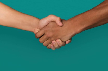 Handshake against blue background.